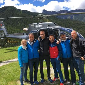 Group picture infrot of a helicopter.