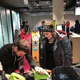 two people are looking at a snowboard