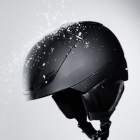 Black Atomic Revent helmet with falling snow.