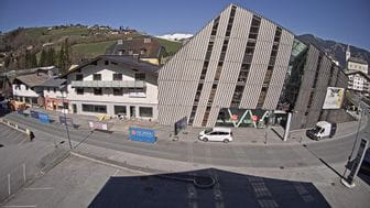 Bründl Sports flagshipstore in Kaprun and the buildings next to it on a beautiful spring day