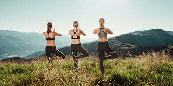 three women doing yoga at Schmittenhöhe