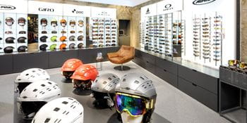 Ski Helmets in the fourground, ski and sports googles in the back <br/>