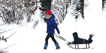 Women with child and toboggan