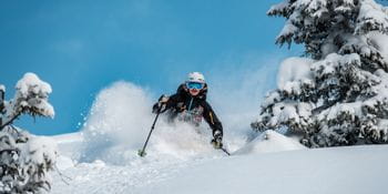 A skier skiing in deep snow
