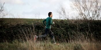 A man running wearing on running shoes and clothes
