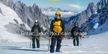 Three mountaineers connected by a rope, wearing helmets and backpacks and carrying poles, stand in snow beneath steep rocky peaks. The image features the Salewa logo and the text “Enter your Mountain Space”.