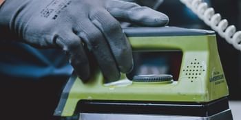 The iron runs over the ski and distributes the hot wax on the base.