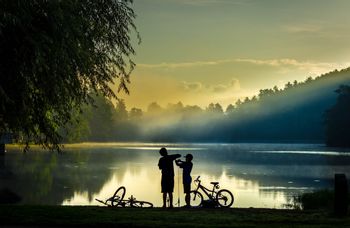 Children infront of a lake with their new bikes
