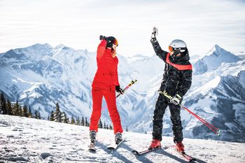 Two skiers highfiveing