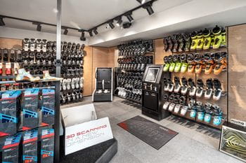 Bründl Sports Saalbach Zentrum - a wall full of skiboots and tools to make your skiboots fit better