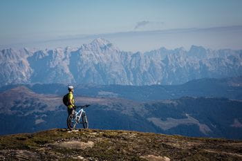 a biker in front of mountains in Zell am See