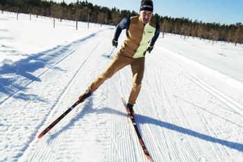 A man dressed in the new Adidas Terrex winter collection while cross-country skiing. 