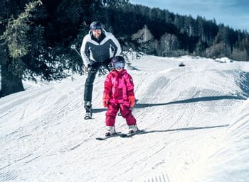 Father and girl skiing in Kaprun