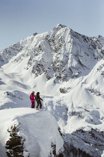 a freeride couple checking out their next lines