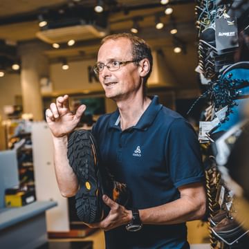an employee presents a hiking shoe