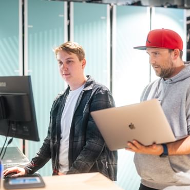 Two IT service technicians checking the technology at Rent Check-in