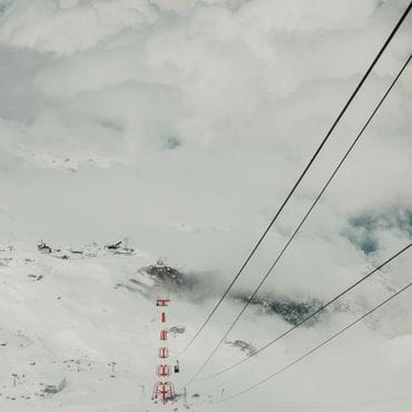Picture from the gondola, you can see the mountains and clouds.<br/>