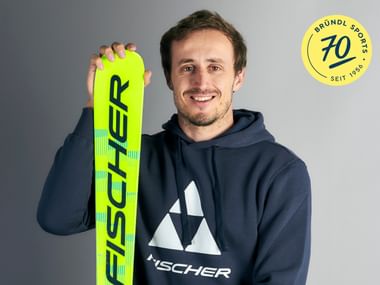 Ski athlete Stefan Brennsteiner holding a Fischer ski