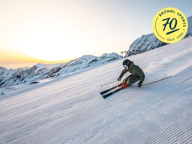 Skier in the morning on groomed piste