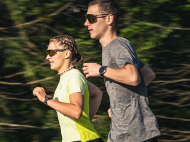 Running couple wearing sunglasses