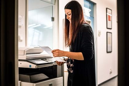 an apprentice uses a printer in office