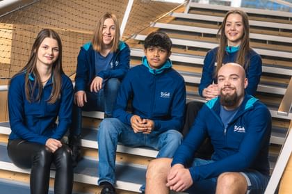 apprentices sitting on stairs