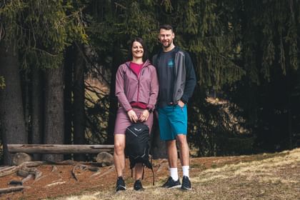 2 people in outdoor clothing - hiking in the woods - shooting for outdoor booklet.