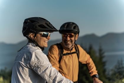 Two bikers with black helmets looking at each other