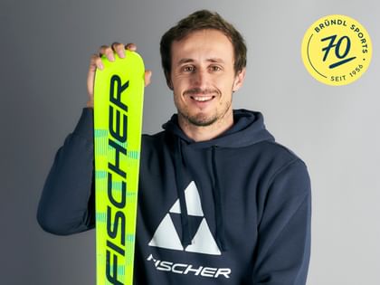 Ski athlete Stefan Brennsteiner holding a Fischer ski
