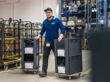 Tom moves crates of goods through logistics