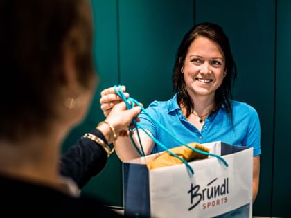 a store employee hands over the product at the checkout counter