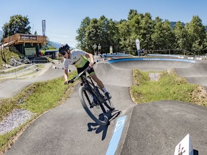 Biking child on the pumptrack of the Bike Base Bruck