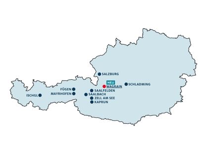 A simplified map of Austria is shown in light blue. Several locations such as “Salzburg,” “Schladming,” “Saalfelden,” “Saalbach,” “Zell am See,” “Kaprun,” “Mayrhofen,” “Fügen,” and “Ischgl” are marked, while “Wagrain” is highlighted with a red dot and the label “New.”