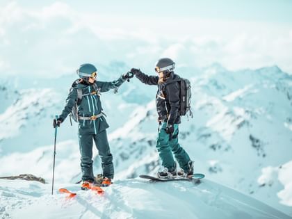 Eva Walkner and Manuela Mandl on the top of a mountain before a freeride run wearing their new julbo oneline goggles