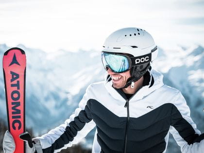Portrait of a skier with skis
