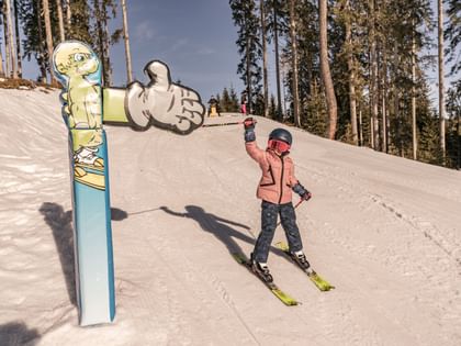 A kid skiing at Schmittenhöhe. 