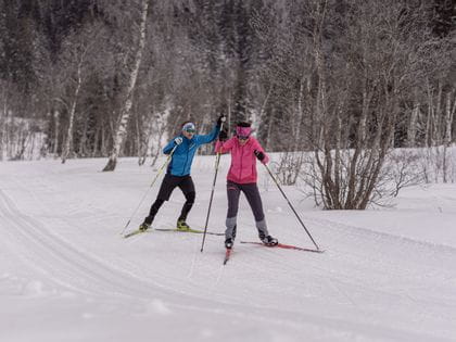 Man and woman cross-country skiing in Mittersill, pass thurn
