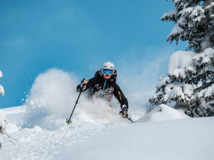 A skier skiing in deep snow