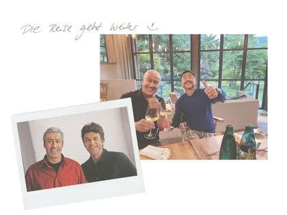 Collage mit zwei Fotos von jeweils zwei Männern: auf einer älteren Aufnahme stehen sie nebeneinander, auf der aktuellen stoßen sie mit Weingläsern an und zeigen den Daumen nach oben. Darüber steht handschriftlich „Die Reise geht weiter :)“.