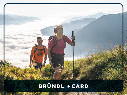 <br/>BRÜNDL +CARD Key Visual - A happy couple enjoys a summer hike in the mountains.