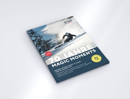 Mock-up of the Bründl Sports anniversary Magic Moments Magazine celebrating 70 years, featuring a skier on the cover. Visible text includes “70 Jahre Magic Moments”, “Menschen machen Momente. Seit 1956.” and the Bründl Sports logo.