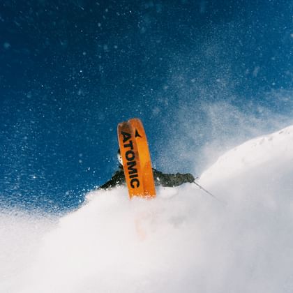 A freeride skier with atomic skis