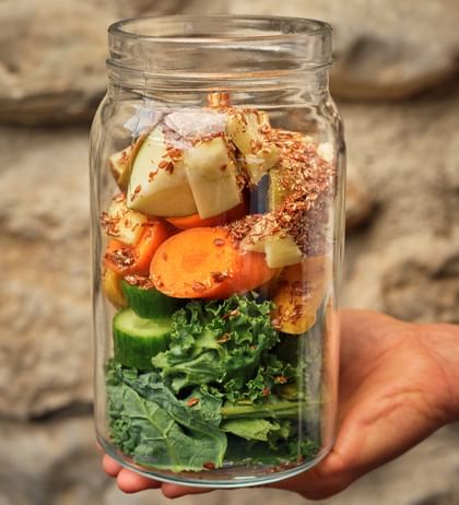 Ein Glas gefüllt mit Gemüse und Obst