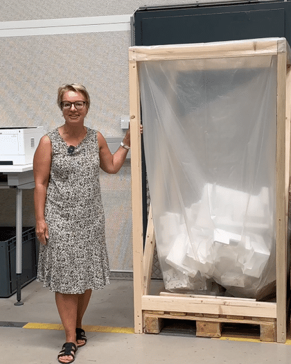 Bründl Sports employee infront of wastepaper basekt