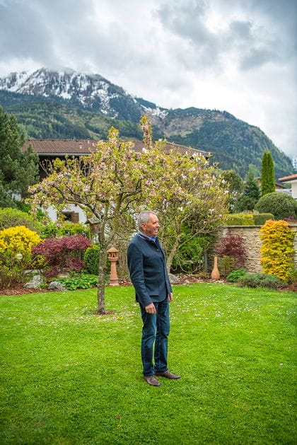 Alois Moreau standing in his backyard